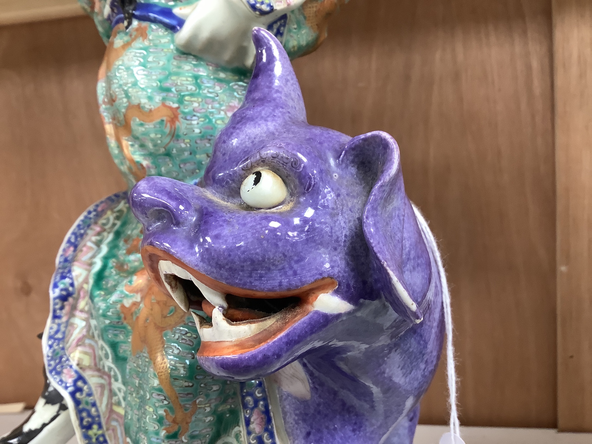 A Chinese enamelled porcelain figure group of an immortal on a mythical beast, Republic period, height 33cm